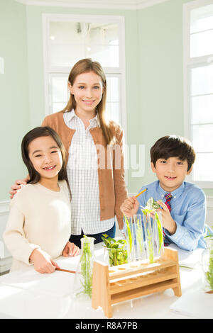 Young Students In Biology Class With A Female Teacher Stock Photo