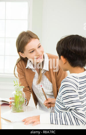 Young Student In Biology Class With A Female Teacher Stock Photo