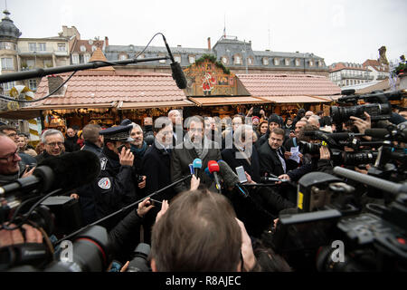 Strasbourg, France. 14 December 2018, France (France), Strassburg: French Interior Minister Christophe Castaner (M, La République en Marche) makes a statement at the Christmas market. Two days after the terrorist attack in Strasbourg with three dead, police killed the alleged assassin. Photo: Marijan Murat/dpa Credit: dpa picture alliance/Alamy Live News Stock Photo