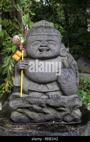 Fukuoka, Japan - October 19, 2018: Stone Ebisu statue, the Japanese god of fishermen and luck, he is one of the Seven Gods of Fortune