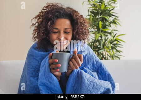 Sick woman drinks hot drink during cold weather Sick woman drinks hot drink during cold weather