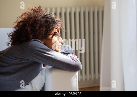 Woman feeling negative emotions lying on the sofa