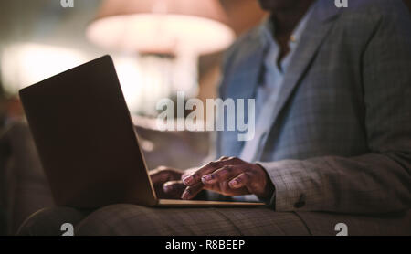 Close up of woman hands using laptop. Businesswoman working on laptop computer at hotel lobby.