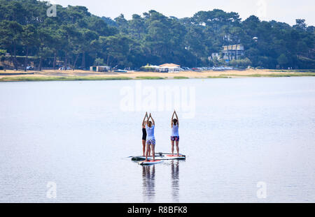 Stand Up Paddle Yoga, Hossegor Lake, France Stock Photo