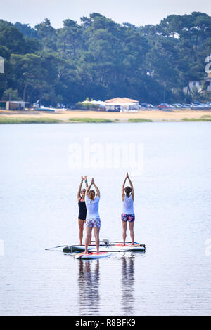 Stand Up Paddle Yoga, Hossegor Lake, France Stock Photo