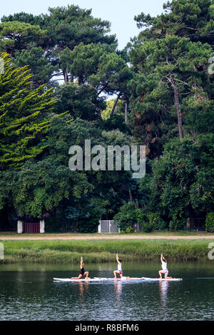 Stand Up Paddle Yoga, Hossegor Lake, France Stock Photo