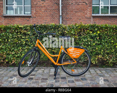 Orange bike from Donkey Republic bike rental, Copenhagen, Denmark, Scandinavia Stock Photo