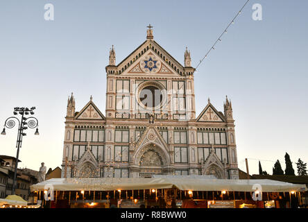 Florence, ITALY - DECEMBER 2018: Christmas Market in front of the 'Basilica of Santa Croce'. Xmas atmosphere, Italy. Stock Photo