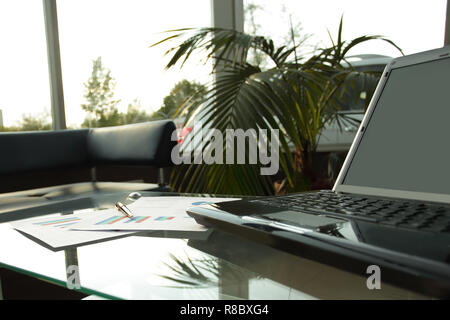close up. open laptop on the table in the lobby of a modern Bank Stock Photo
