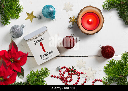 tear-off calendar surrounded by christmas decoration and with the 1st of january 2019 (in German) on top Stock Photo