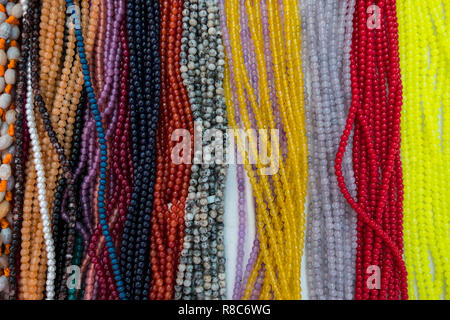 Wallpaper background of colorful necklace made of gemstones and colored beads showcased in a shop. Semi precious jewelery. Stock Photo