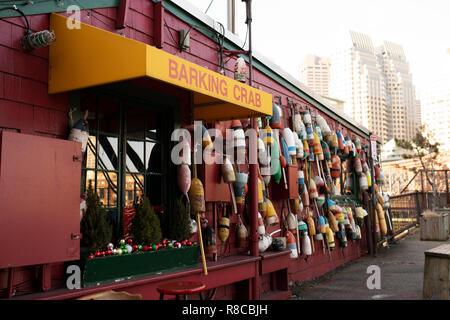 Buoys decorate the outside of the Barking Crab, a Boston restaurant that sits on the water in the Fort Point Channel. Stock Photo