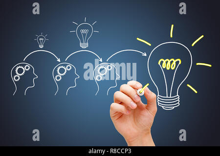 Synergy business team working together on development of a great idea. If everybody gives a little, it adds up. Stock Photo
