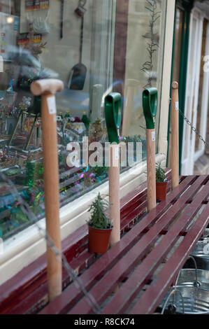 Fork handles (or four candles) on display, for sale outside an ironmongers in Bradford on Avon, Wiltshire, UK Stock Photo