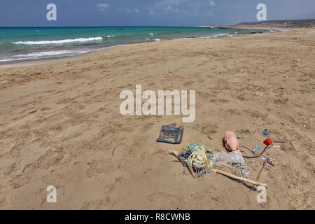Beautiful empty wild beach in Karpass, Cyprus, with rubbish on the sand. Ocean littering concept. Stock Photo