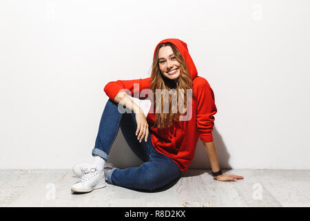 Young slim woman in white hoodie sitting, Stock Video