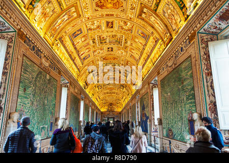 Wall and ceiling paintings in the Gallery of Maps with tourists wandering around at the Vatican Museum, Vat Stock Photo