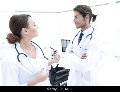 Two Doctors Having Meeting In Hospital Reception Area Stock Photo