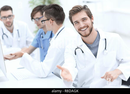 friendly doctor making a welcome gesture Stock Photo