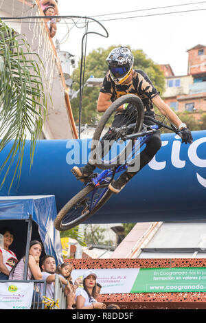 Biker touring the track during the Downhill Challenge Medellin 2018. Cycling event that was held this December 2, 2018 in the neighborhoods of the 13t Stock Photo