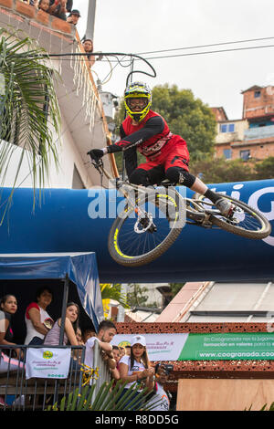 Biker touring the track during the Downhill Challenge Medellin 2018. Cycling event that was held this December 2, 2018 in the neighborhoods of the 13t Stock Photo