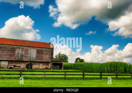 Rural West Virginia country scene with barn, pasture and corn field under cloudy skies. Stock Photo