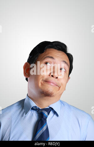 Photo image portrait of a handsome young Asian businessman getting bored and being lazy Stock Photo