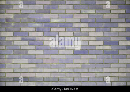 The texture of wall from a variety of old and dirty brick. Detailed pattern of a plurality of different sizes of brick colored worn out Stock Photo