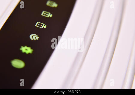 Closeup of internet router LED lights showing connection status. Emitting diode wireless on white plastic internet wi-fi cable modem Stock Photo