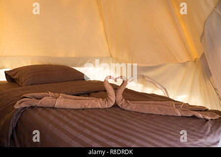 Greeting in hotel room towels in swan shapes, Towel art, maid service. Stock Photo