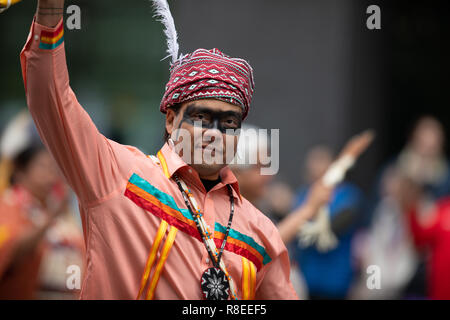 Houston, Texas, USA - November 22, 2018 The H-E-B Thanksgiving Day Parade, Native American man wearing traditional clothing waves at the camera Stock Photo