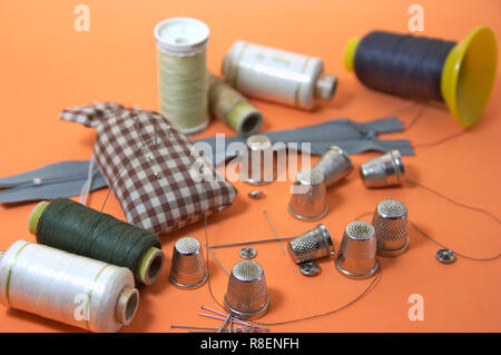 Set of useful things for home or professional sewing, such as needles, thread or thimbles Stock Photo