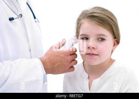 Doctor taking girl's temperature using digital thermometer Stock Photo