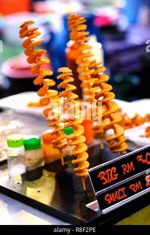 Fried twisted potato - traditional asian street food. Asian, Indian and Chinese street food. Food court on local market of Langkawi island, Malaysia. Stock Photo