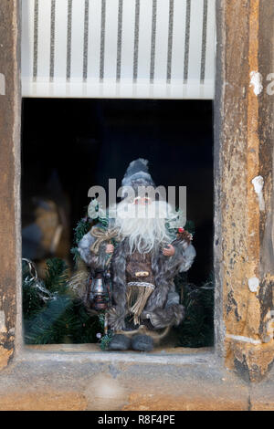 Santa Claus figure in a cottage window. Chipping campden, Cotswolds. Gloucestershire, England Stock Photo