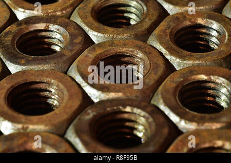 Closeup of a pile of rusty nuts. Retro industrial concept Stock Photo