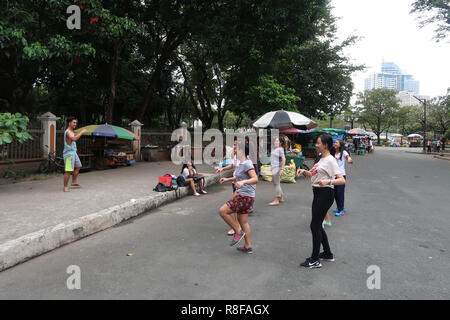 A group of young Filipinos teenagers training to perform flash mob in the street in the Agrifina Circle, Rizal Park, Manila Philippines Stock Photo