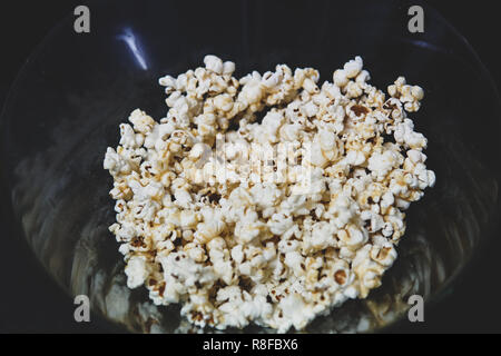 Fresh popcorn in a transparent bowl Stock Photo