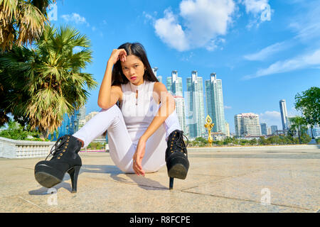 Beautiful woman posing - sitting, tired, mad and serious Stock Photo