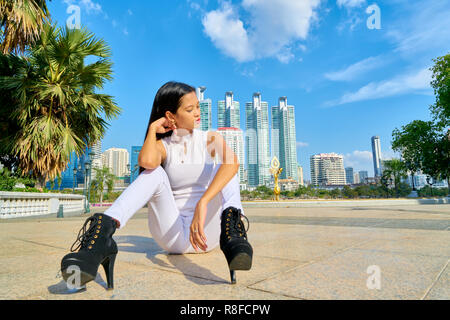 Beautiful woman posing - sitting, looking down, tired and thinking Stock Photo