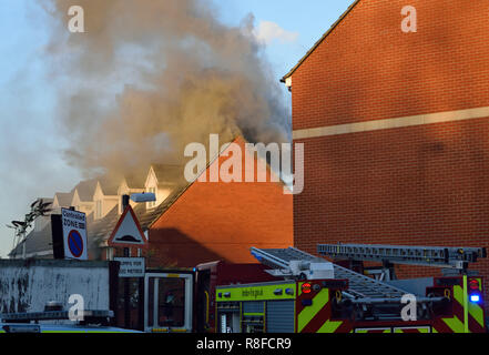 Emergency services respond to a house fire in a residential street in East London with a number of Fire Engines including an Aerial Platform Stock Photo