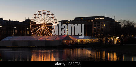 Christmas Market by Lille Lungegaardsvannet Lake in downtown Bergen, Norway. Ferris wheel and tents. Stock Photo