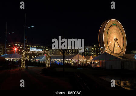 Christmas Market by Lille Lungegaardsvannet Lake in downtown Bergen, Norway. Ferris wheel rotating. Stock Photo