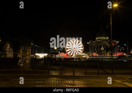 Christmas Market by Lille Lungegaardsvannet Lake in downtown Bergen, Norway. Ferris wheel rotating. Stock Photo