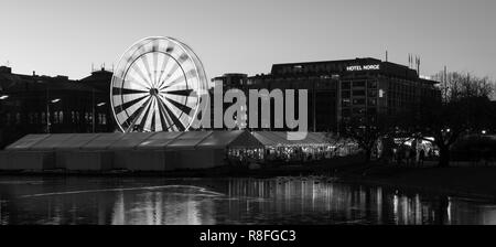 Christmas Market by Lille Lungegaardsvannet Lake in downtown Bergen, Norway. Ferris wheel rotating. Stock Photo