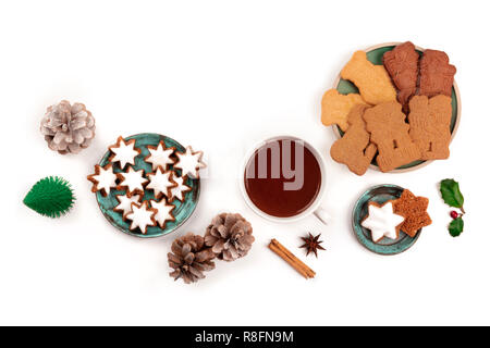 A photo of Zimtsterne and Spekulatius, traditional Christmas cookies, shot from the top on a white background with hot chocolate and spices Stock Photo