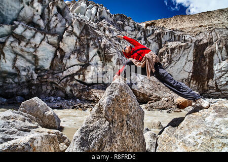 Back view of young slim woman practicing yoga in hills. Flexible female  sitting on legs, bending on yoga mat in mountains. Concept of new age  religion Stock Photo - Alamy