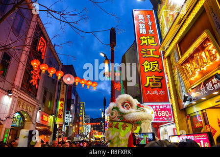 Crowded shopping streets at Chinatown in Yokohama during Chinese New Year in Japan. Text on signboard is the individual restaurants name. Stock Photo