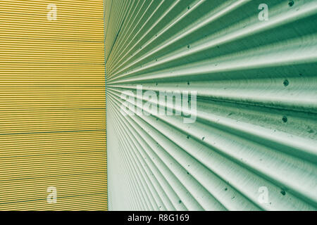 Green and yellow corrugated metal sheet wall background texture. Stock Photo
