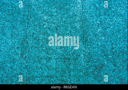 Closeup of a Blue colored mosaic Stone Wall usable as decorative Background, Surface or Texture. Stock Photo